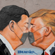 Street art shows US President Donald Trump and Chinese President Xi Jinping wearing protective mask and kissing at a section of the former Berlin Wall at Mauerpark during the novel coronavirus crisis on April 26, 2020 in Berlin, Germany. Germany is taking its first steps to ease restrictions on public life that had been imposed weeks ago in order to stem the spread of the coronavirus.